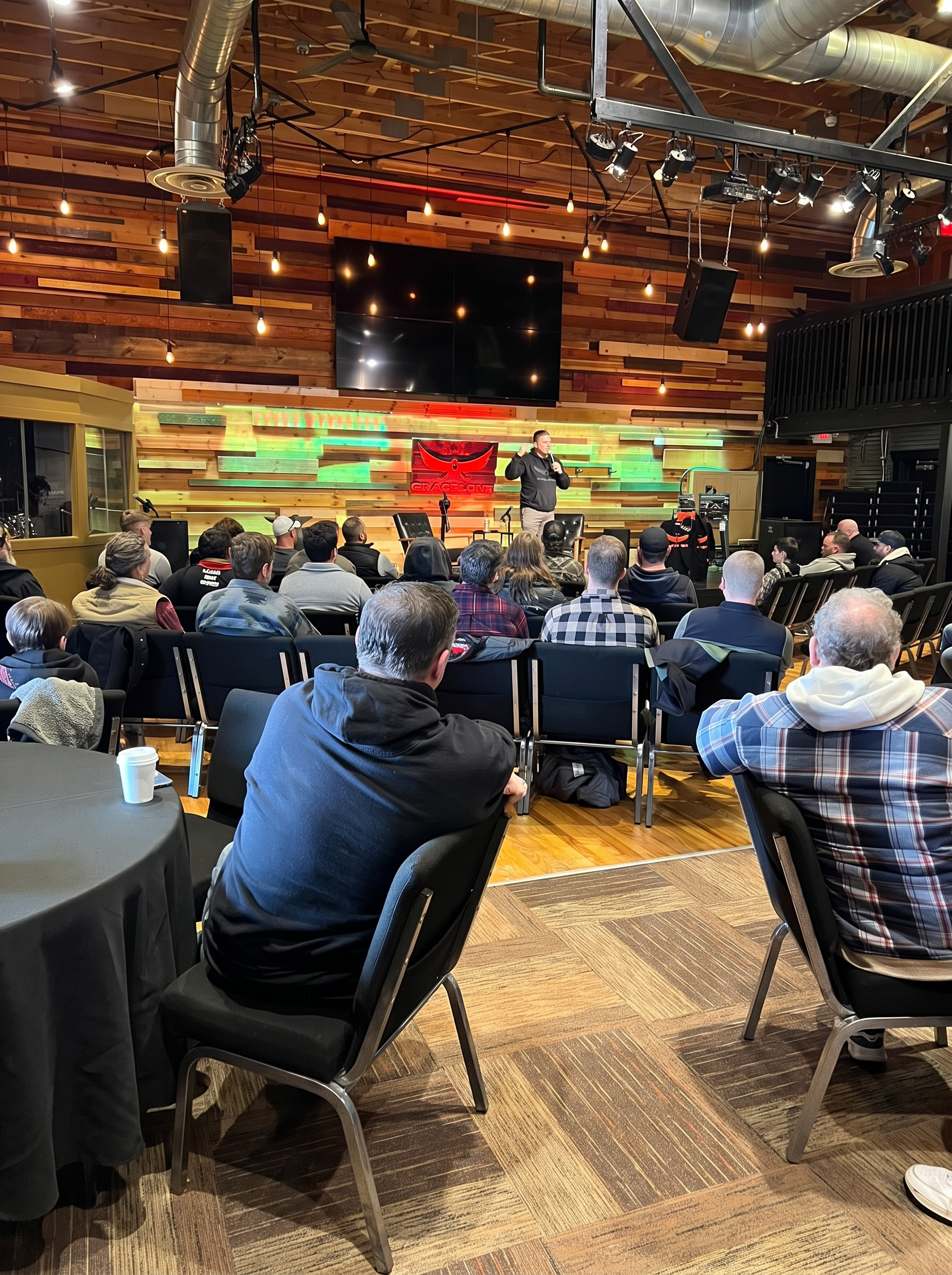 Men gathered at a Grace Ops night beneath the Grace Ops banner